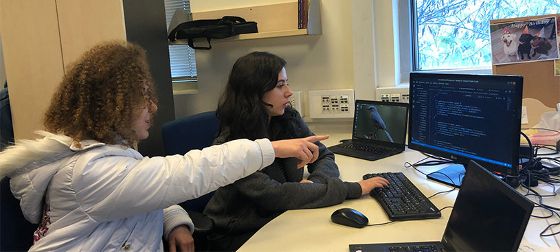 Ayelet Ganot, left, and Roni Ashkenazi, participants in the Carmel 6000 national service program, work on an app intended to help autistic children cope with change. (Sam Sokol)